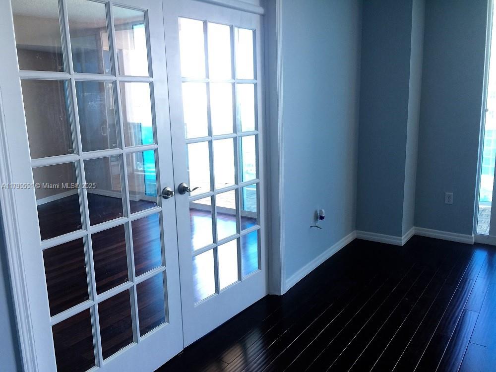 1881 79th Street Causeway, Unit 1106 North Bay Village, FL 33141 - Photo 18 of 20 a view of an empty room with wooden floor and a window