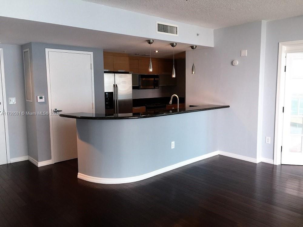 1881 79th Street Causeway, Unit 1106 North Bay Village, FL 33141 - Photo 7 of 20 a view of a living room with wooden floor