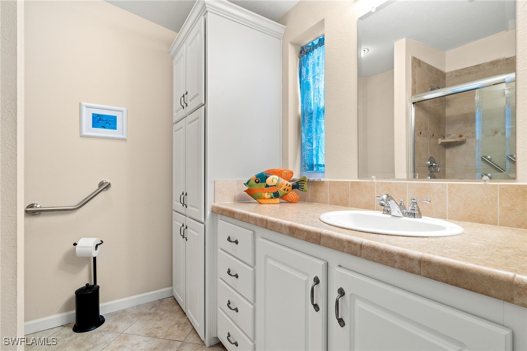 3057 Waterview Point Naples, FL 34120 - Photo 17 of 31 a bathroom with a sink and a mirror