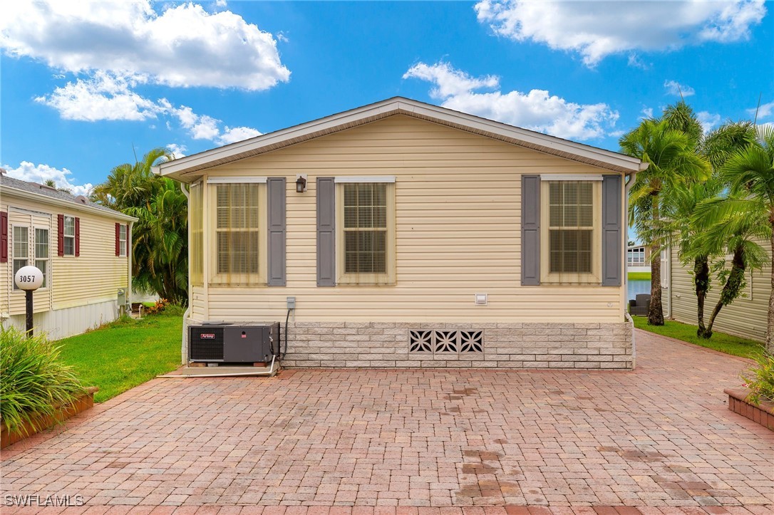 3057 Waterview Point Naples, FL 34120 - Photo 2 of 31 a front view of a house with a garden