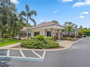 3057 Waterview Point Naples, FL 34120 - Photo 26 of 31 a front view of a house with a yard and palm trees