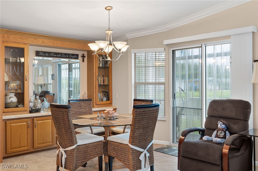 3057 Waterview Point Naples, FL 34120 - Photo 8 of 31 a view of a dining room with furniture large windows and wooden floor