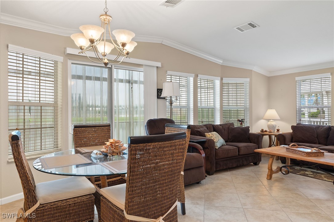 3057 Waterview Point Naples, FL 34120 - Photo 9 of 31 a living room with furniture or chandelier and a dining table