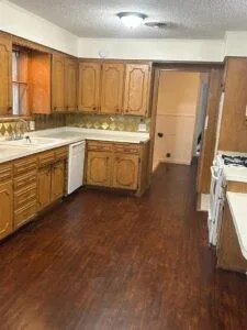 a kitchen with a sink window and cabinets