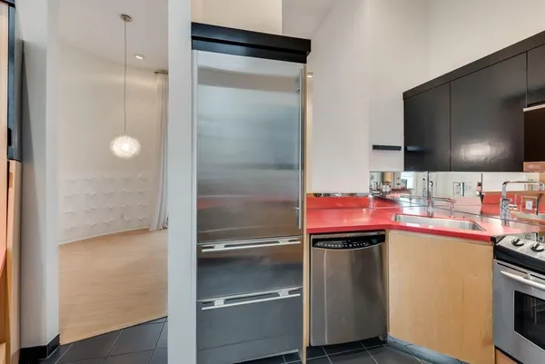 a kitchen with a refrigerator and a sink
