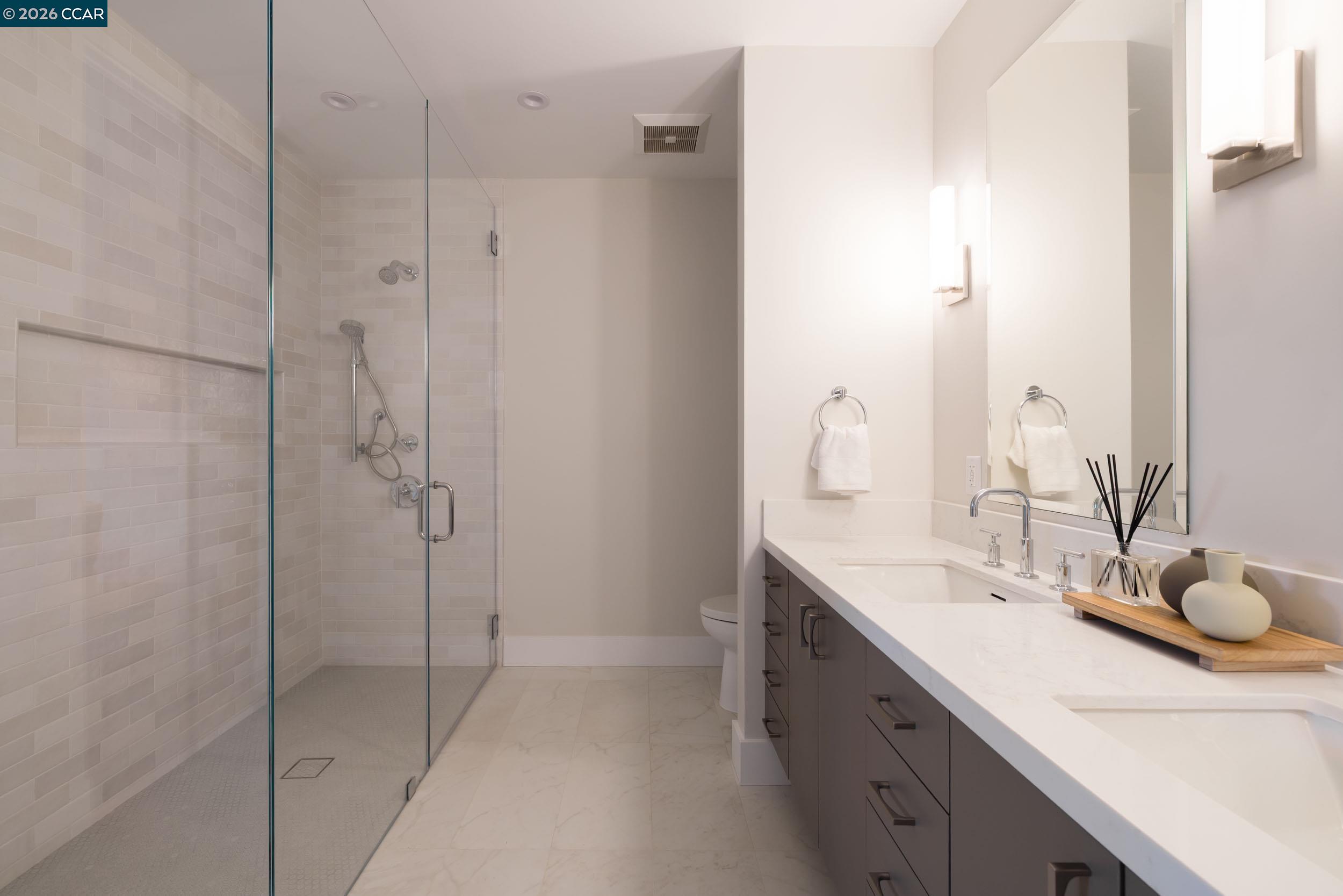 950 Hough Avenue, Unit 202 Lafayette, CA 94549 - Photo 18 of 38 a bathroom with a double vanity sink mirror and shower