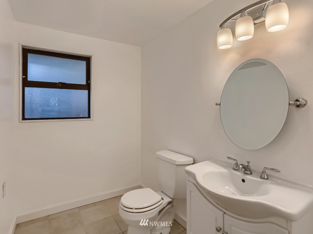 102 233rd Place Southwest Bothell, WA 98021 - Photo 21 of 26 a bathroom with a toilet sink and mirror