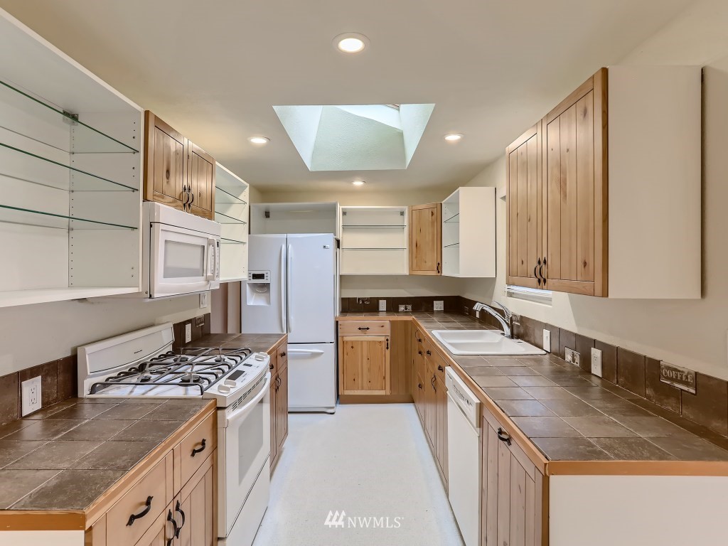 102 233rd Place Southwest Bothell, WA 98021 - Photo 8 of 26 a kitchen with a stove sink and refrigerator