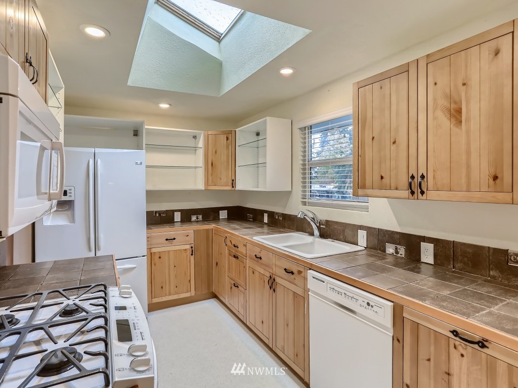 102 233rd Place Southwest Bothell, WA 98021 - Photo 10 of 26 a kitchen with a sink stove and cabinets