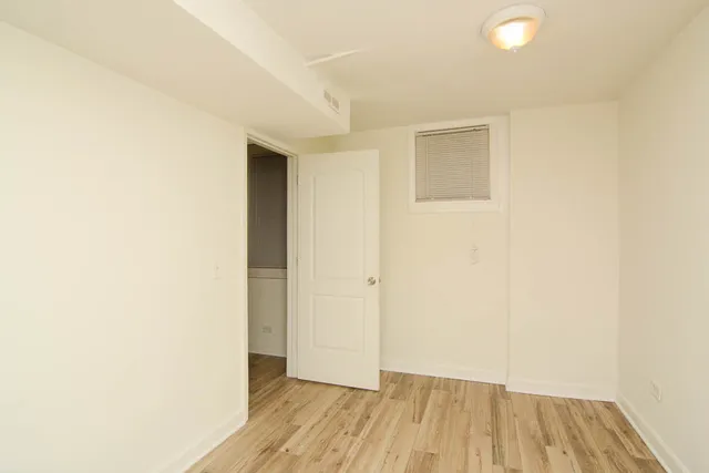 a view of a room with wooden floor and a ceiling fan
