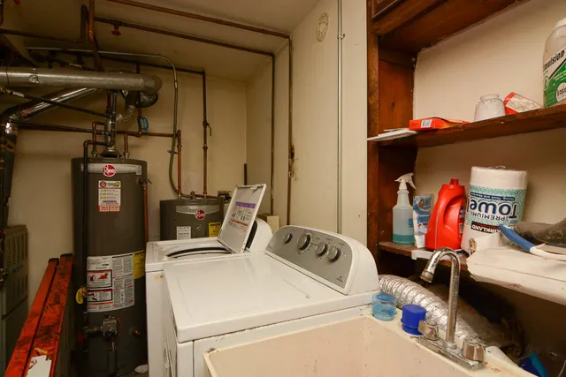 a utility room with dryer washer and other items