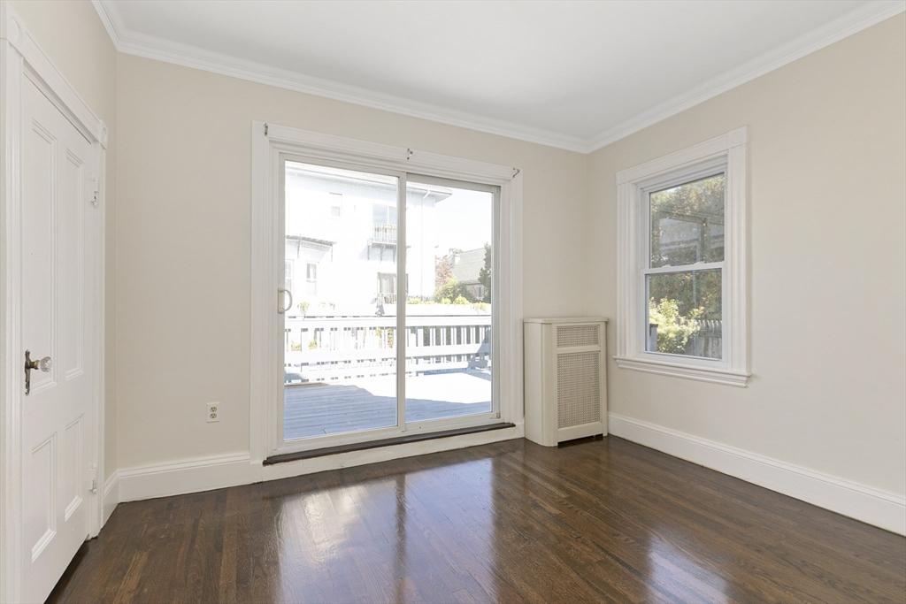 15 South Fairview Street, Unit 3 Boston, MA 02131 - Photo 12 of 29 a view of an empty room with wooden floor and a window