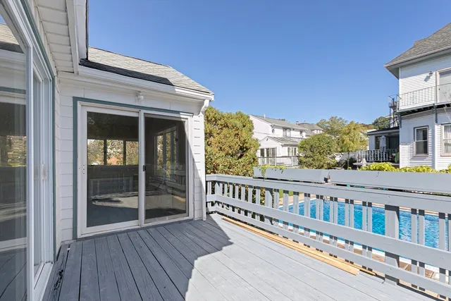 a view of a house with a wooden deck