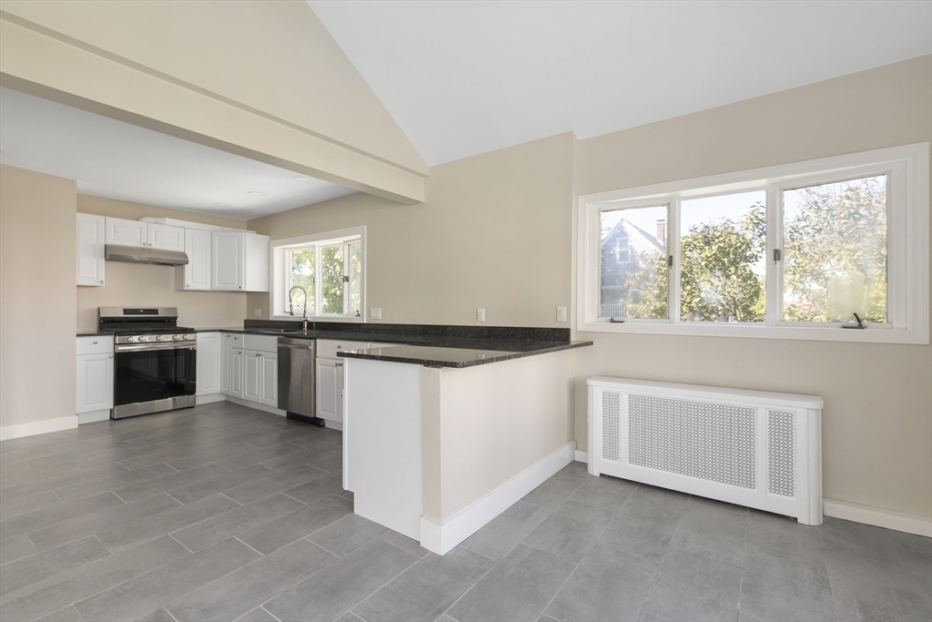 15 South Fairview Street, Unit 3 Boston, MA 02131 - Photo 7 of 29 a kitchen with stainless steel appliances granite countertop a stove a sink and a microwave