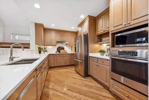 a kitchen with stainless steel appliances a refrigerator and a stove