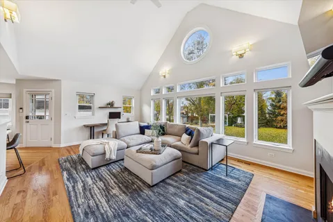 a bedroom with a bed wooden floor and a flat screen tv