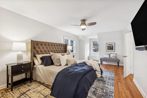 a bathroom with a granite countertop sink a toilet and a large mirror