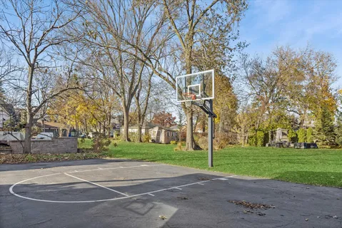 a view of backyard with outdoor seating and trees