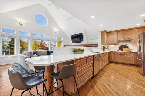 a kitchen with stainless steel appliances a stove sink microwave and cabinets