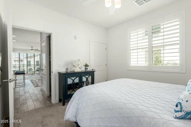 a bedroom with a bed and a table with window