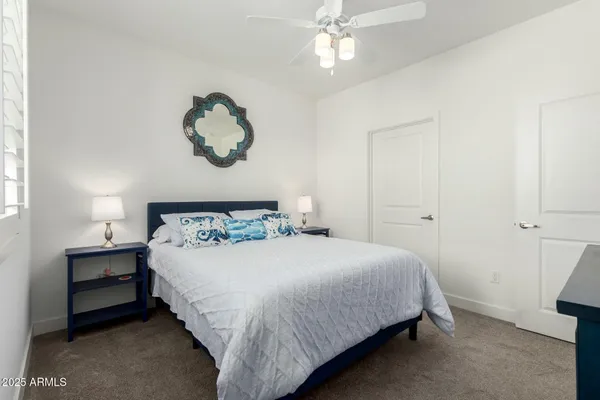 a bedroom with a bed and a chandelier