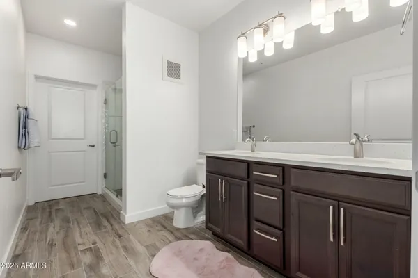 a bathroom with a sink toilet and shower