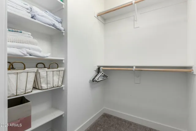 a view of walk in closet with empty racks