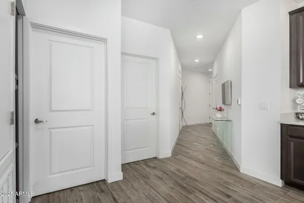 a view of a hallway with wooden floor