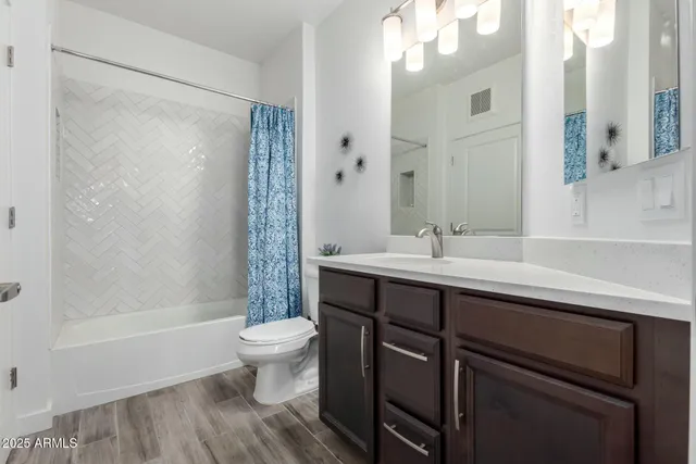 a bathroom with a sink a toilet a shower and a mirror