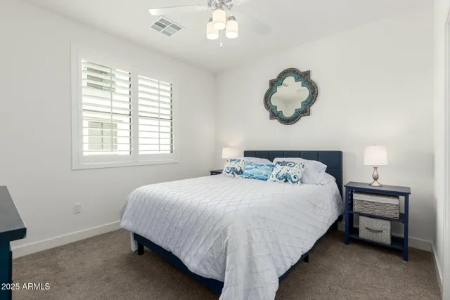 a bedroom with a bed and chandelier