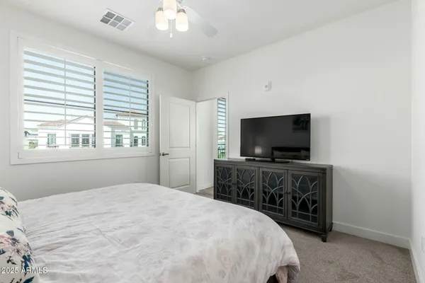 a bedroom with a bed and a flat screen tv