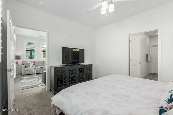 a bedroom with a bed and a flat screen tv