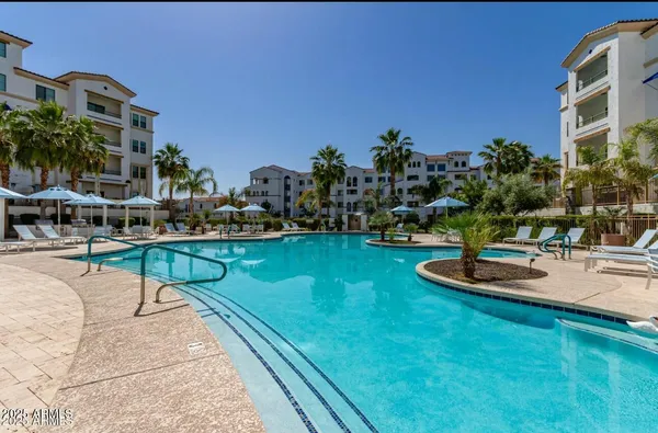 a swimming pool with outdoor seating and yard
