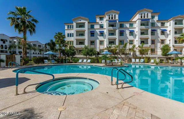 a view of a swimming pool with a garden and plants