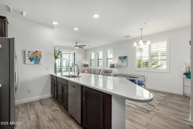 a large kitchen with kitchen island a large counter space and wooden floor