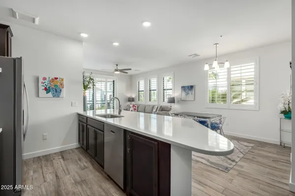 a large kitchen with kitchen island a large counter space and wooden floor