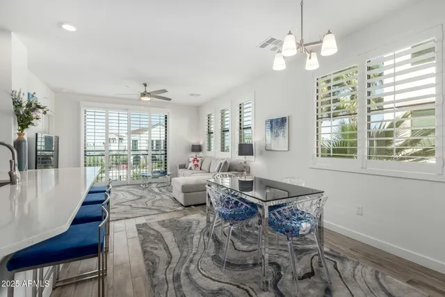 a living room with fireplace furniture and a chandelier