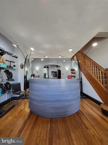 a room with wooden floors and lots of tables