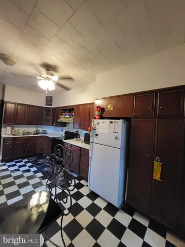 a kitchen with a refrigerator and a stove