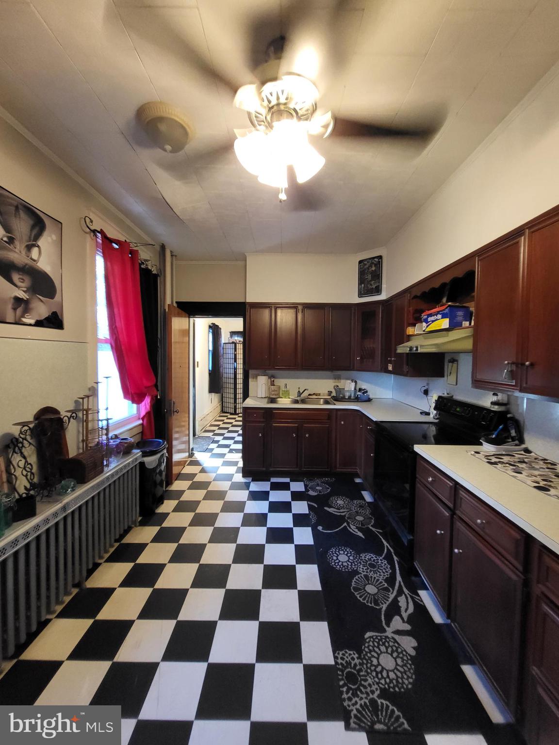 402 Morgantown Road Reading, PA 19611 - Photo 14 of 47 a kitchen with a checkered floor and white cabinets