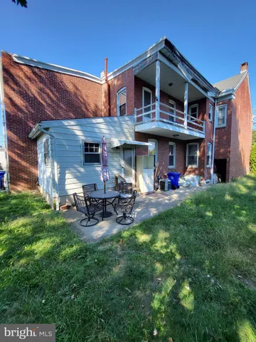 a view of a chairs and tables in the back yard of the house