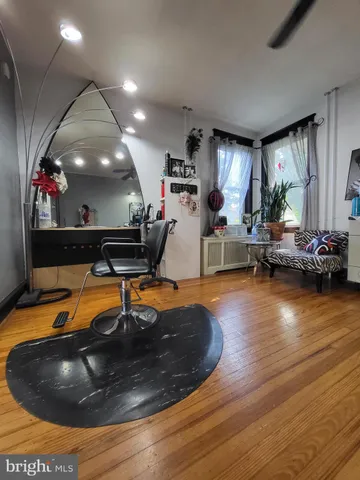 a room with wooden floor pool table and furniture
