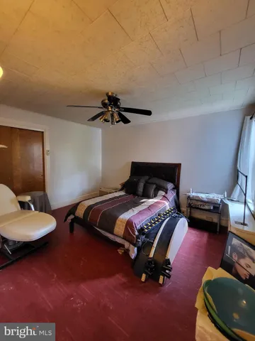 a bedroom with a bed and a couch