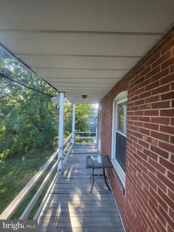a view of a patio with wooden floor and iron stairs