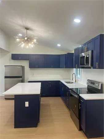 a kitchen with stainless steel appliances granite countertop a sink counter space and cabinets