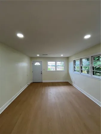 an empty room with a empty space and windows