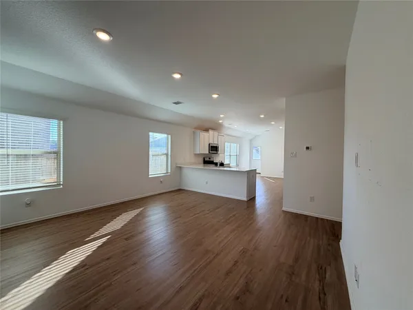 a kitchen with stainless steel appliances granite countertop a stove and white cabinets