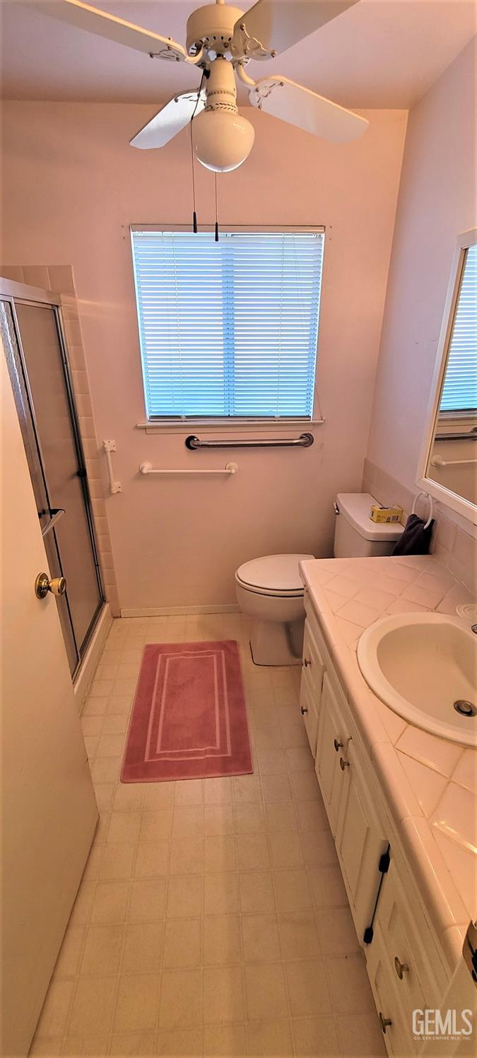 Undisclosed Address Delano, CA 93215 - Photo 11 of 23 a bathroom with a toilet a sink and mirror