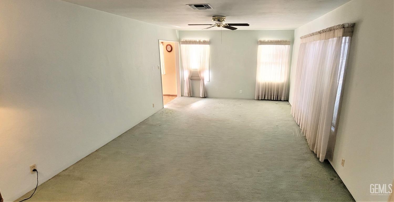 Undisclosed Address Delano, CA 93215 - Photo 3 of 23 an empty room with windows and cabinet