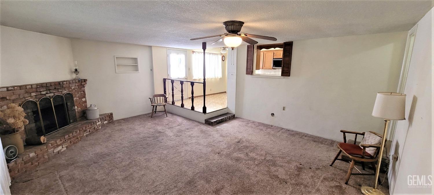 Undisclosed Address Delano, CA 93215 - Photo 7 of 23 a view of livingroom with furniture and fireplace